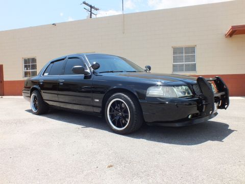 2003 Ford Crown Victoria - Right front 3/4; blacked-out Crown Vic, spotlights, brush guard, lowered on black wheels