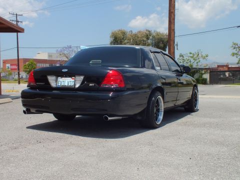 2003 Ford Crown Victoria - Rear 3/4; Police Interceptor and SVT trunk badges, EVIL VIC California plate, twin pipes