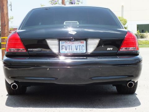 2003 Ford Crown Victoria - Tight rear; POLICE INTERCEPTOR and SVT badges flank EVIL VIC plate, twin chrome tips