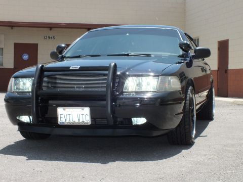 2003 Ford Crown Victoria - Head-on view of a black Crown Victoria with push bar and EVIL VIC plate.