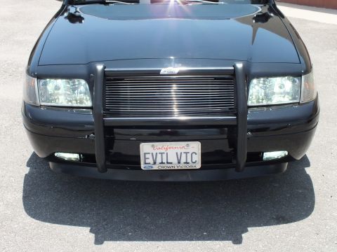 2003 Ford Crown Victoria - Close front view of a black Crown Victoria billet grille and EVIL VIC plate.