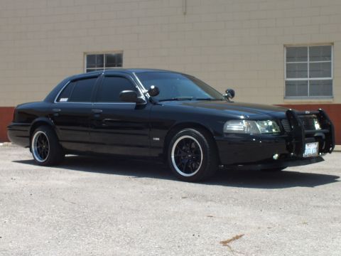 2003 Ford Crown Victoria - Front-quarter of a lowered black Crown Victoria with grille guard in a lot.