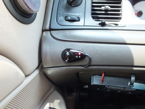 2003 Ford Crown Victoria - Close dash view of an installed aftermarket switch beside the headlight control and vents.