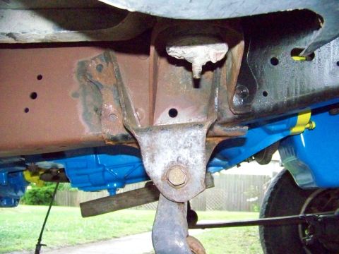 1985 Ford Bronco - Underside view of a vehicle's frame and suspension, showing rust and recently painted parts.