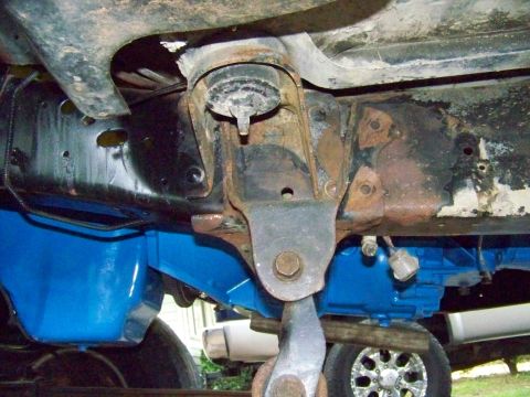 1985 Ford Bronco - Close-up view of the undercarriage, highlighting freshly painted blue suspension parts and the vehicle's frame.