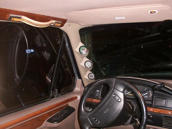 SUV interior with A-pillar triple gauge pod and Ford steering wheel