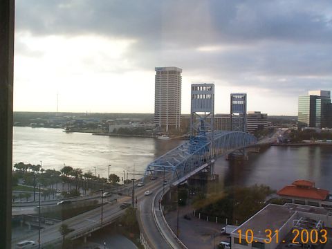 1992 Ford Bronco - A view of the Jacksonville skyline and the Acosta Bridge, with cars crossing the bridge and traffic on the roads below.