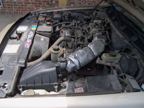 2000 Mercury Grand Marquis - Engine bay of a 2000 Mercury Grand Marquis shows the V8 engine and custom air intake.