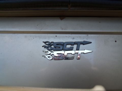 2000 Mercury Grand Marquis - Close-up of SCT emblems on a vehicle's exterior.