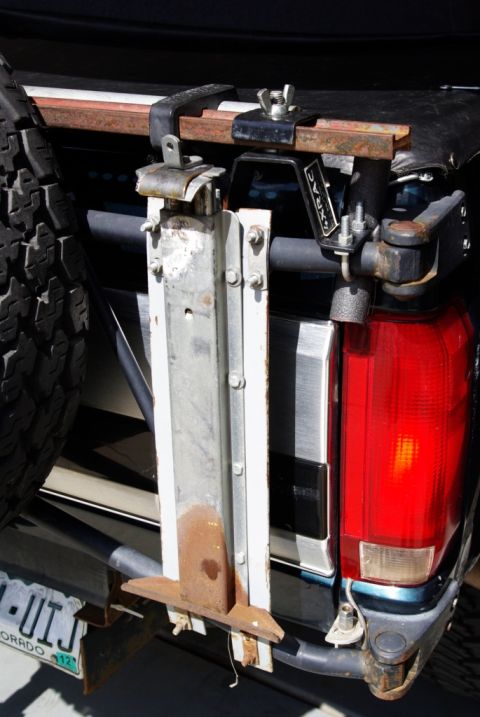 1995 Ford Bronco - This close-up shot focuses on the rear of a vehicle, highlighting its spare tire carrier and taillight assembly.