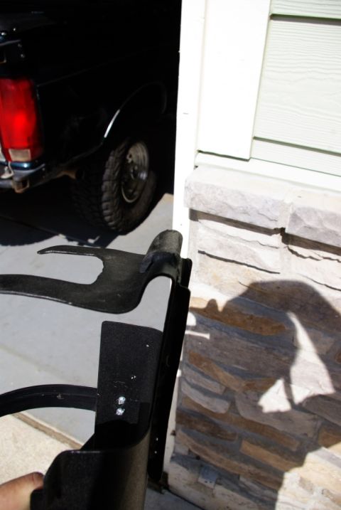 1995 Ford Bronco - A black SUV is partially visible, parked near a stone and siding wall.