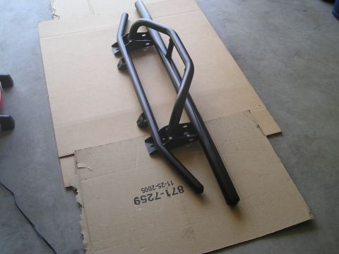 1999 Ford Ranger - Black metal side steps are laid out on cardboard, with a part number visible on the packaging.
