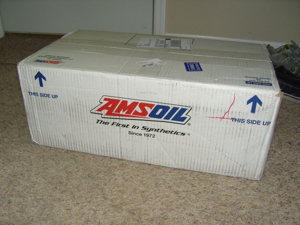Cardboard box with AMSOIL logo and "The First in Synthetics Since 1972" text