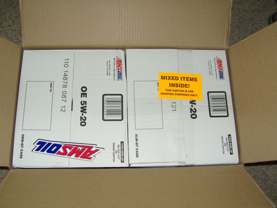 Photo of two Amsoil motor oil shipping cartons inside a cardboard box