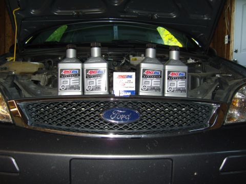2007 Ford Mustang - Front grille of a Ford Focus with AMSOIL oil bottles and a filter displayed.