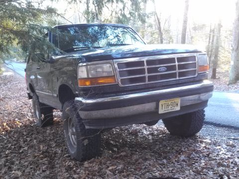 1995 Ford Bronco - 1995 Ford Bronco XLT in a wooded area. New Jersey license plate YTH-90W is visible.