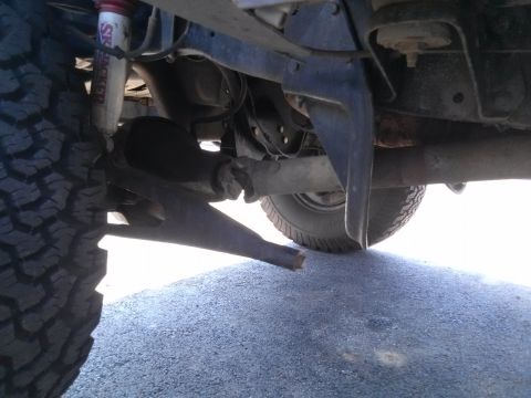 1995 Ford Bronco - This photo shows the undercarriage of a vehicle, focusing on the suspension and drive train components.