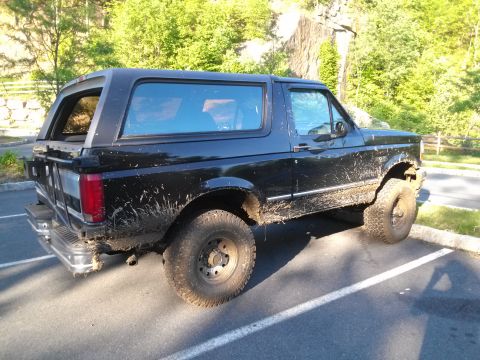 1995 Ford Bronco - This 1995 Ford Bronco appears to have recently been off-roading, as evidenced by the mud splattered on its body.