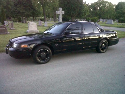 1999 Ford Crown Victoria - A black 1998 Ford Crown Victoria sedan is parked in a cemetery.