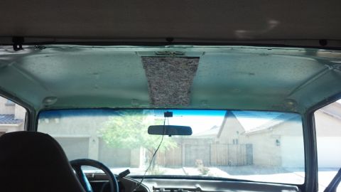 1995 Ford Bronco - View from inside a vehicle, looking through the windshield at the headliner and exterior.