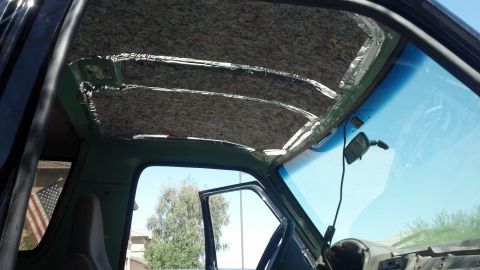 1995 Ford Bronco - The headliner of the vehicle has been removed, exposing the internal structure and insulation material.