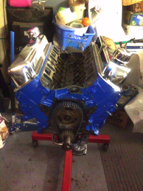 1993 Ford Bronco - V8 engine with chrome valve covers on a red engine stand, ready for installation.