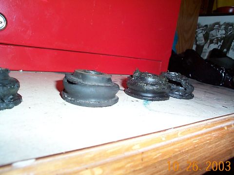 1992 Ford Bronco - Several damaged rubber bushings are visible on a surface, with a red cabinet in the background.