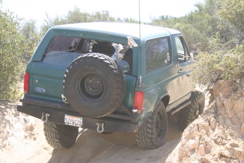 1991 Ford Bronco - 1991 Ford Bronco navigating a rocky, off-road trail.