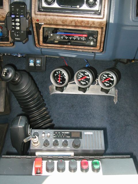 1985 Ford Bronco - Interior view of a vehicle with added gauges and a CB radio, likely modified for off-road use.
