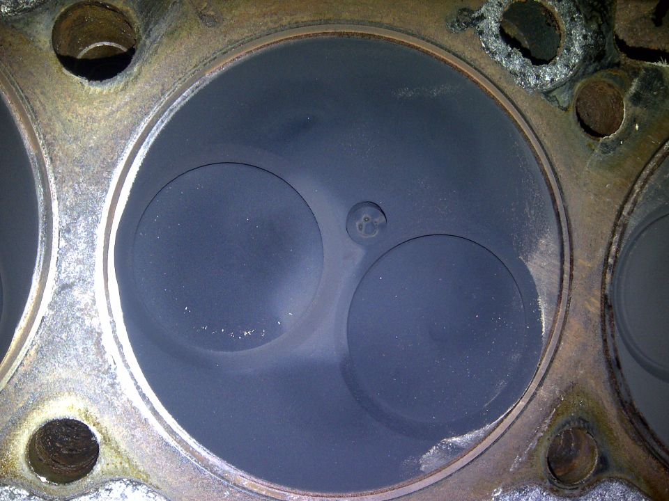 Engine cylinder head showing two valves and combustion chambers