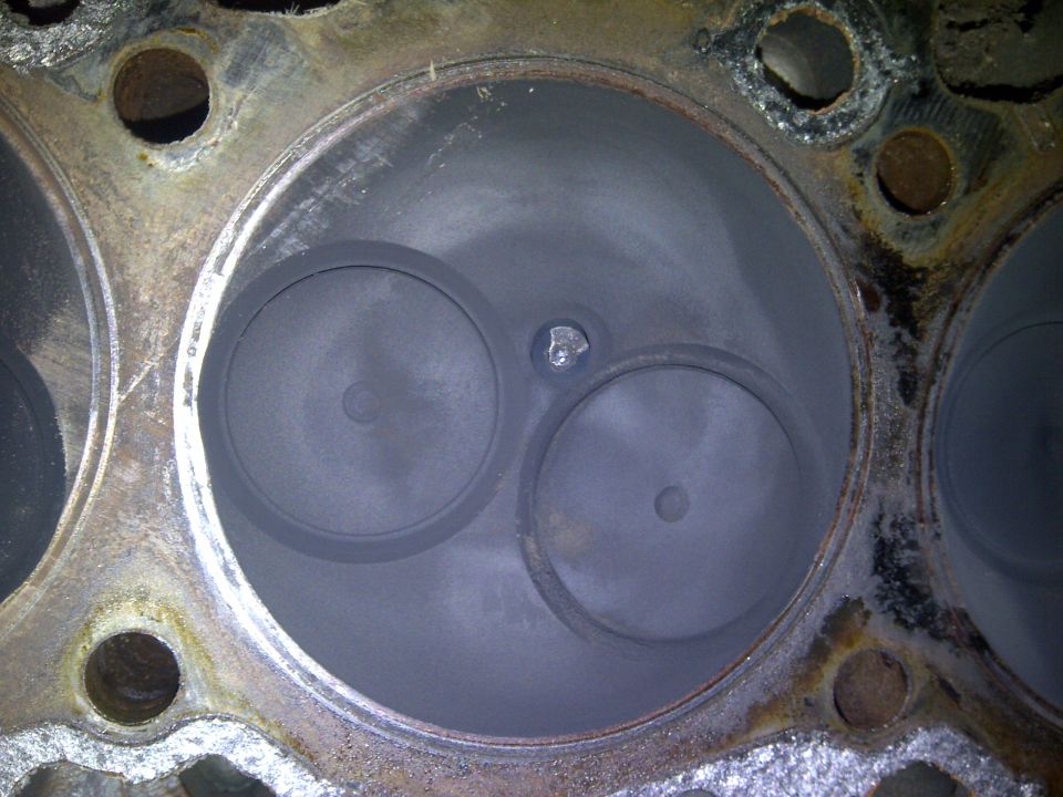 close-up of engine cylinder head with two valves visible