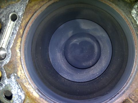 1986 Ford Bronco - Close-up view of an engine cylinder, showing the piston within.