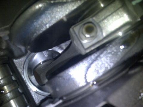 1986 Ford Bronco - Close-up view of an engine's connecting rod and piston assembly.