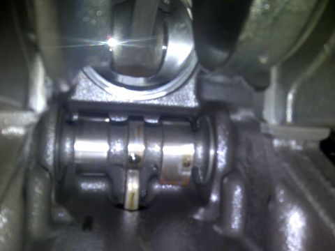 1986 Ford Bronco - Close-up view of internal engine components, specifically the crankshaft and connecting rod.
