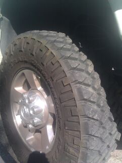 1989 Ford Bronco - A close-up view of a tire and wheel assembly, with "SUPERMOTORS" branding visible.