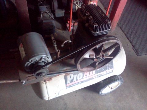 1989 Ford Bronco - This air compressor features a prominent Pro-Air logo and a large drive pulley, indicating it is a component rather than a vehicle.