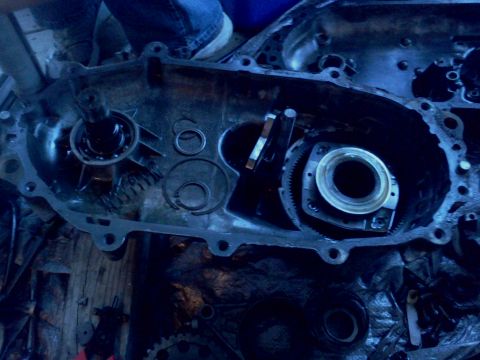 1989 Ford Bronco - Close-up view of a disassembled transmission housing, revealing internal gears and bearings.