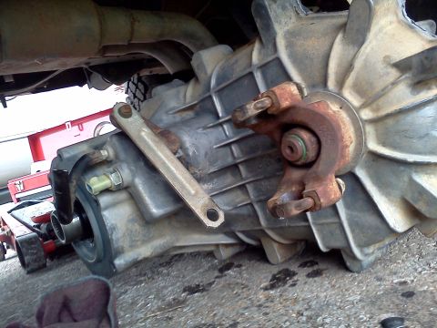 1989 Ford Bronco - Close-up view of a vehicle's transmission and driveshaft components.