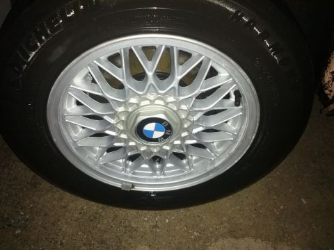 1991 BMW 3 Series - A close-up view of a BMW wheel and tire, showing the intricate design of the alloy rim and the brand's emblem.