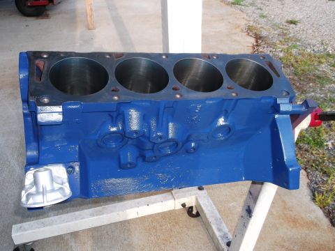 1967 Ford Mustang - V8 engine block painted blue, mounted on a stand for rebuilding or display.
