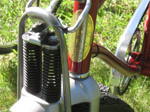 1994 Ford Bronco - Close-up of a red bicycle's front suspension and handlebars, a gold oval badge with stars.