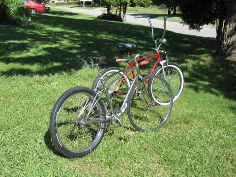 1994 Ford Bronco - Two bicycles are parked on a lawn in front of a residential street.