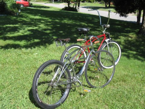 1994 Ford Bronco - Two cruiser bicycles are parked on a grassy lawn with a red car visible in the distance.