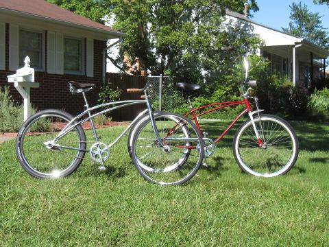 1994 Ford Bronco - Two classic cruiser bicycles sit on the grass outside suburban homes on a sunny day.