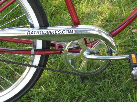 1994 Ford Bronco - A close-up of a bicycle's chain guard with a website sticker is visible against a grassy background.