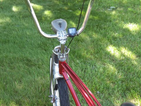1994 Ford Bronco - A close-up view of a bicycle's handlebars and front fork, set against a grassy background.
