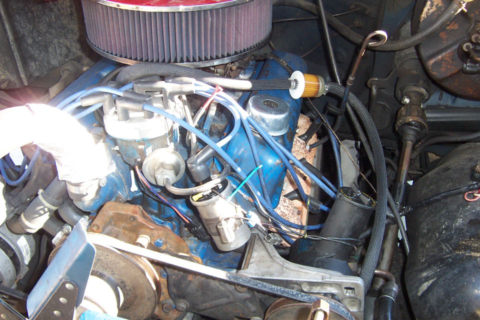 Blue Ford V8 engine bay with distributor and spark plug wires