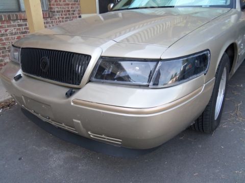 2000 Mercury Grand Marquis - Front view of a 2000 Mercury Grand Marquis with a black grille and tinted headlights.