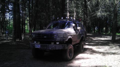 1995 Ford Bronco - This 1995 Ford Bronco is shown in a wooded area, with its exterior covered in dirt.