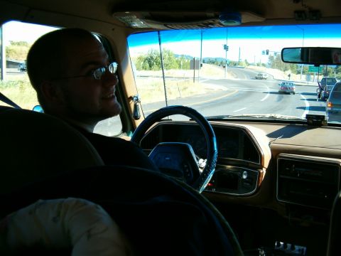 1990 Ford Bronco - Driver's perspective from inside a 1990 Ford Bronco, looking out at a highway intersection.